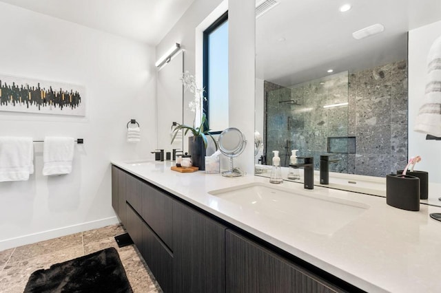 bathroom featuring vanity and tiled shower