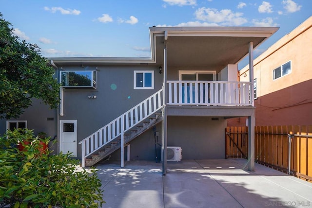 rear view of property featuring ac unit and a patio