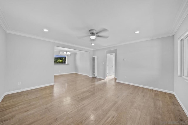 unfurnished living room featuring ceiling fan with notable chandelier, light hardwood / wood-style floors, and crown molding