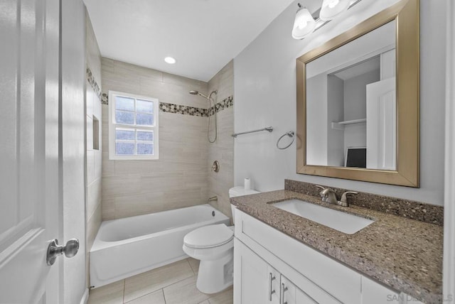 full bathroom with tile patterned floors, vanity, toilet, and tiled shower / bath combo