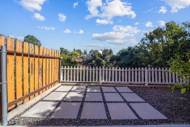 view of gate featuring a patio area