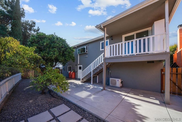 exterior space featuring a wall unit AC, a patio area, and ac unit