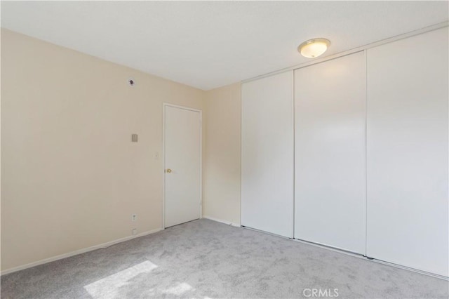 8421 Lindley Ave, Northridge, CA 91325 - unfurnished bedroom featuring light colored carpet, a closet, and baseboards