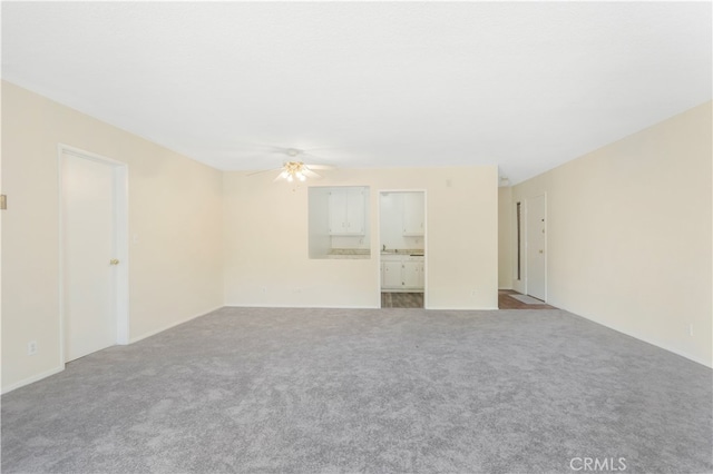 empty room with light carpet and ceiling fan