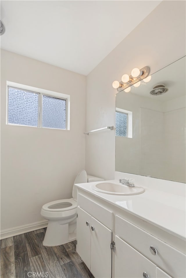 bathroom with vanity, hardwood / wood-style flooring, and toilet