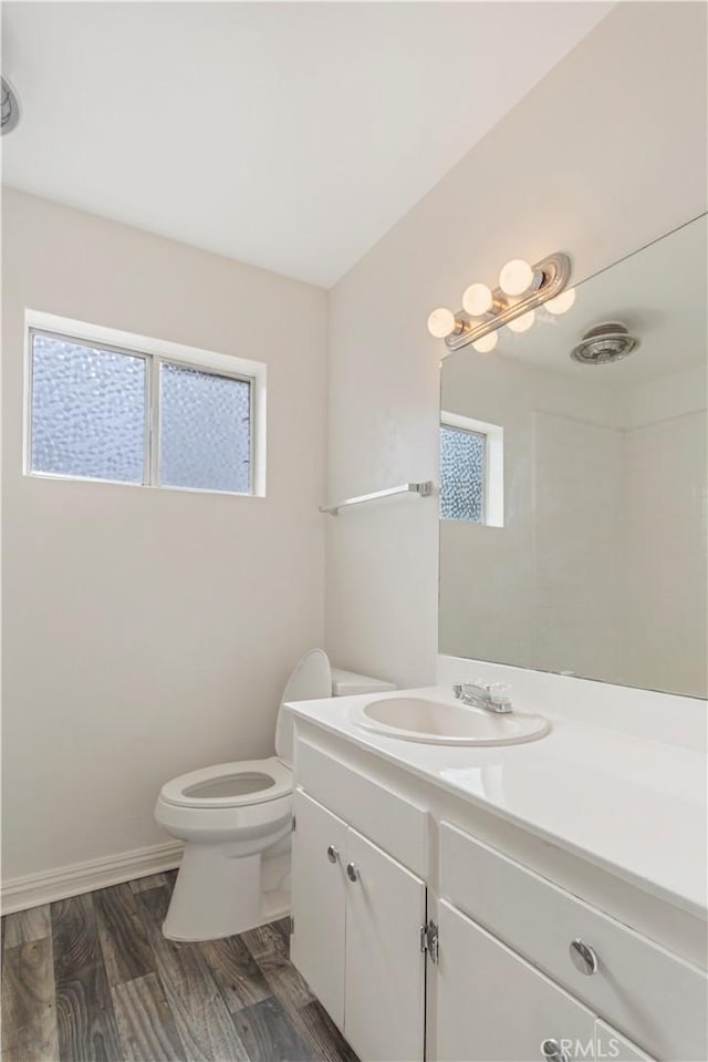 8421 Lindley Ave, Northridge, CA 91325 - bathroom featuring vanity, toilet, healthy amount of natural light, and baseboards