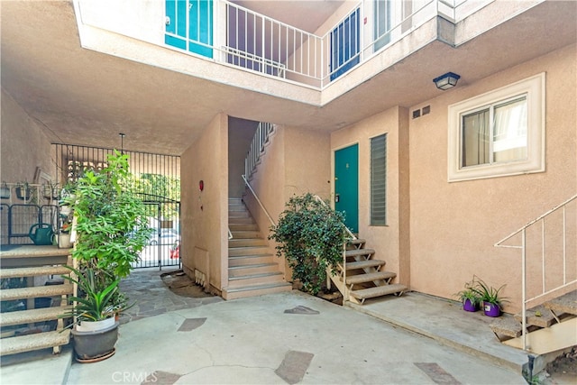 view of exterior entry featuring a balcony