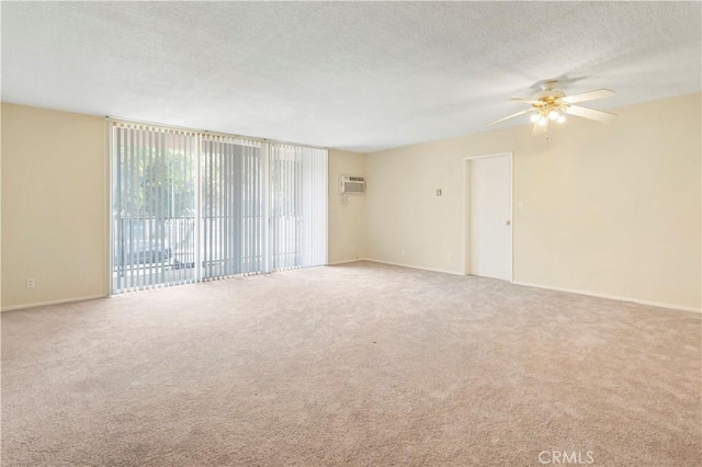 8421 Lindley Ave, Northridge, CA 91325 - unfurnished room with a ceiling fan, carpet floors, a textured ceiling, a wall mounted AC, and baseboards
