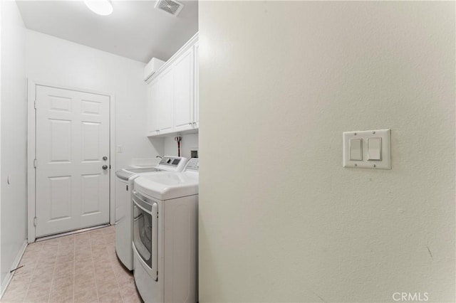 laundry area featuring independent washer and dryer and cabinets