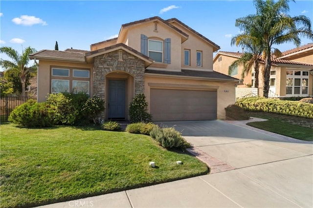 mediterranean / spanish home with a front yard and a garage