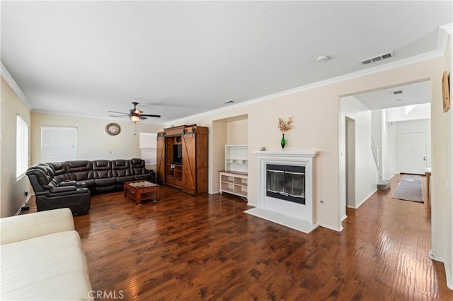 living room with ceiling fan, dark wood-type flooring, and ornamental molding