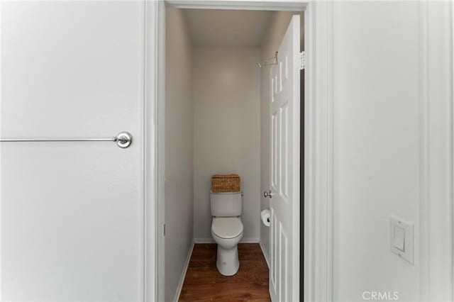 bathroom with toilet and wood-type flooring