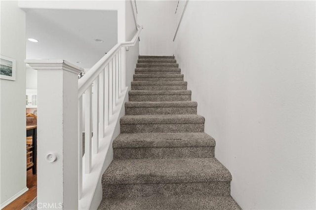 stairs with hardwood / wood-style floors