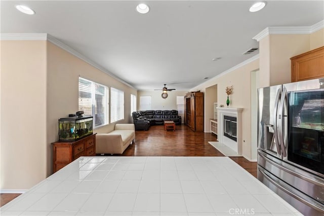 living room featuring ceiling fan, hardwood / wood-style floors, and ornamental molding