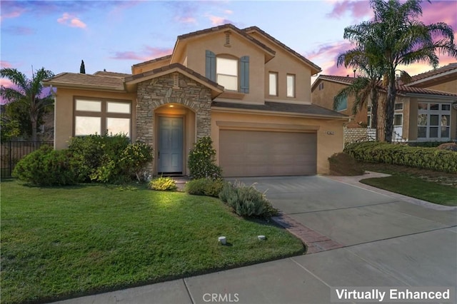 view of front of house featuring a yard and a garage