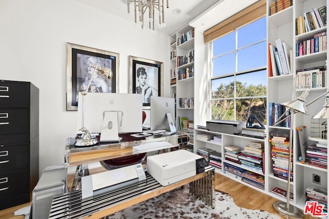 office space featuring hardwood / wood-style floors and a notable chandelier