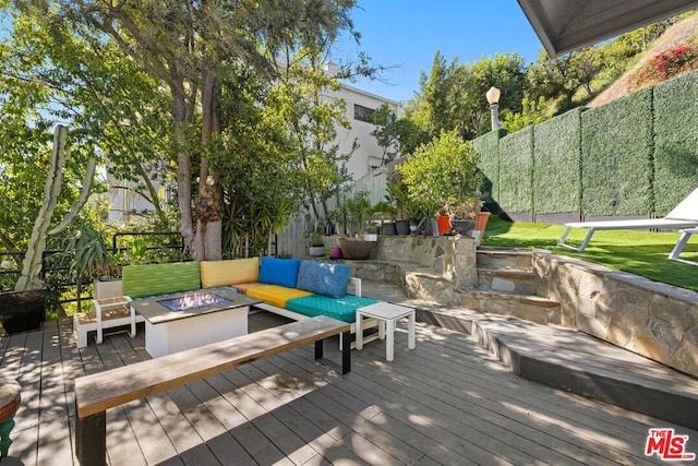 wooden deck featuring an outdoor living space with a fire pit