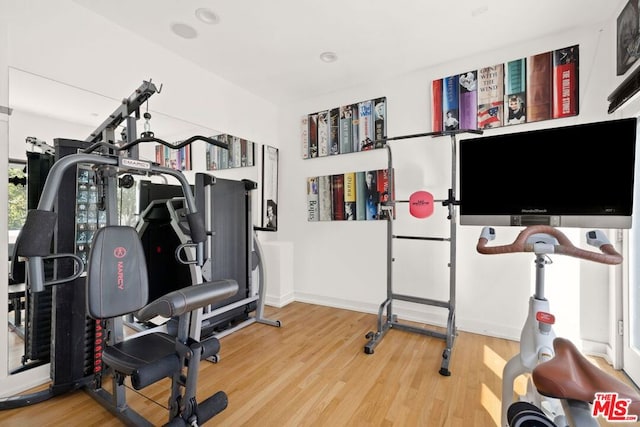 exercise room with hardwood / wood-style floors