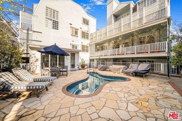 view of pool featuring a patio area