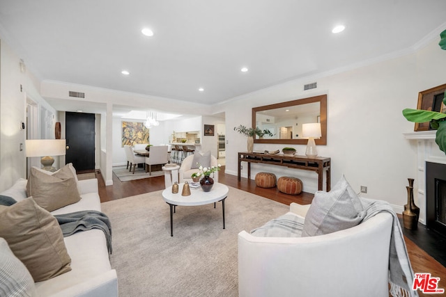 living room with hardwood / wood-style floors and ornamental molding