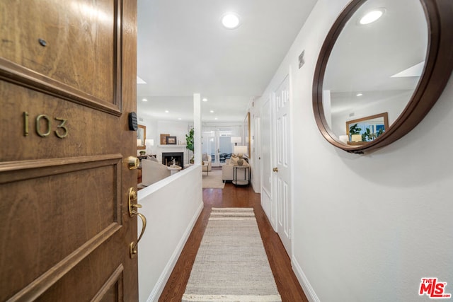 corridor featuring dark hardwood / wood-style flooring