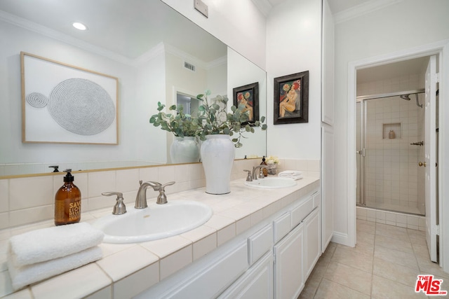 bathroom with tile patterned flooring, crown molding, and walk in shower