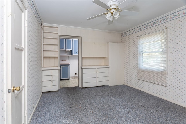 unfurnished bedroom with ornamental molding, carpet, and ceiling fan