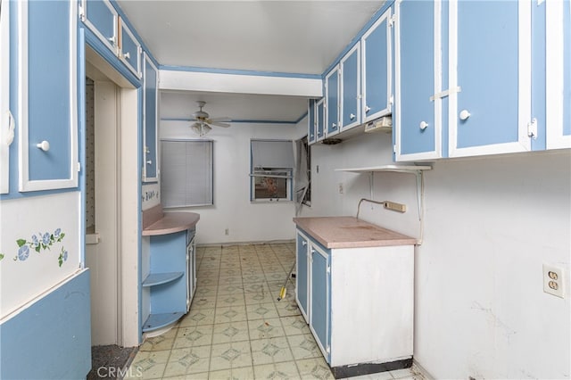 kitchen with blue cabinetry and ceiling fan