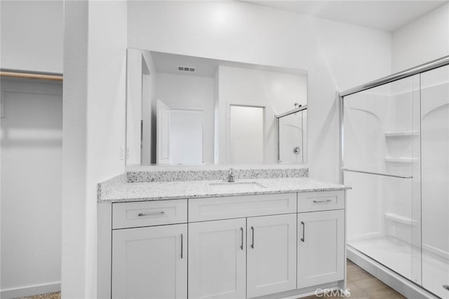 bathroom with vanity and an enclosed shower