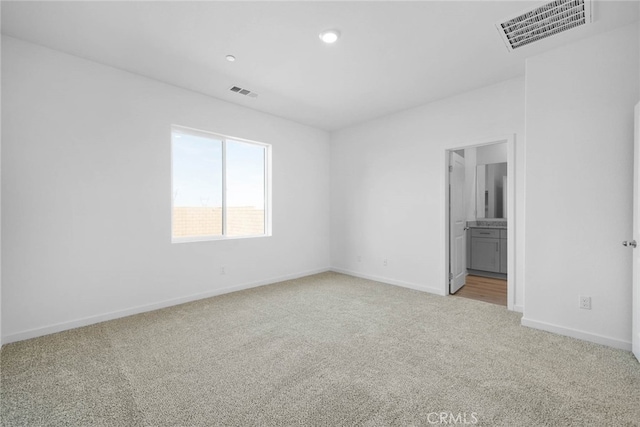 empty room featuring light colored carpet