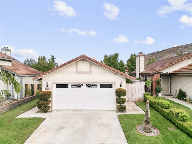 view of front of home featuring a front yard and a garage