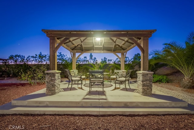 patio terrace at dusk featuring a gazebo