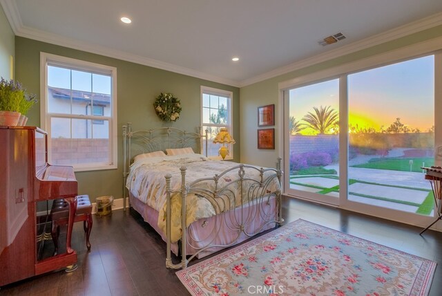 bedroom featuring dark hardwood / wood-style flooring, ornamental molding, access to outside, and multiple windows