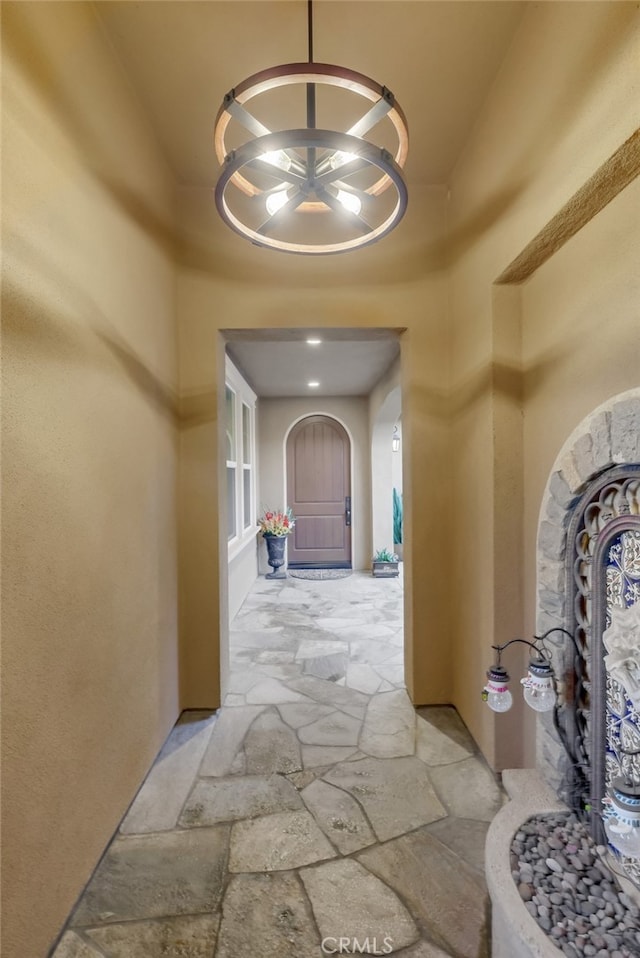 hallway with a chandelier and a high ceiling