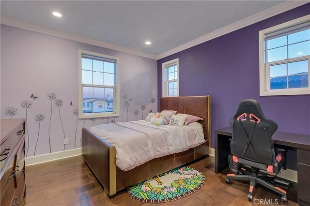 bedroom with hardwood / wood-style flooring, crown molding, and multiple windows