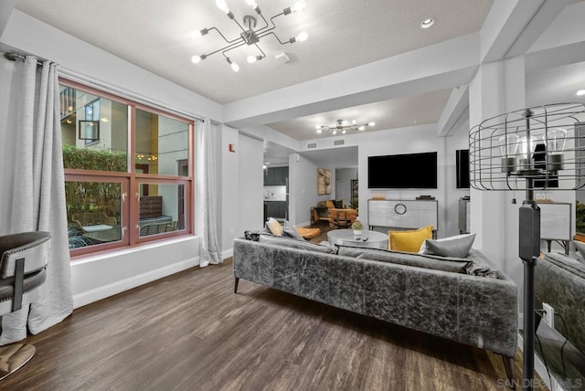 living room featuring a healthy amount of sunlight, hardwood / wood-style flooring, and a notable chandelier