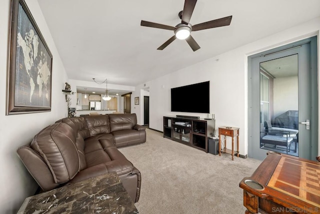 carpeted living room with ceiling fan