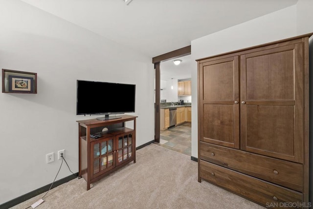 living room with light colored carpet and sink