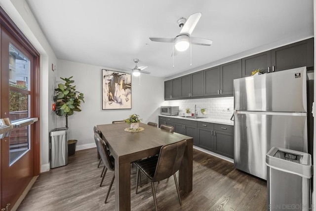 kitchen with stainless steel appliances, tasteful backsplash, sink, dark hardwood / wood-style floors, and gray cabinets