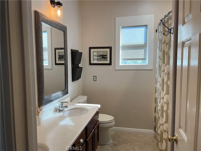 bathroom featuring vanity, toilet, and a wealth of natural light