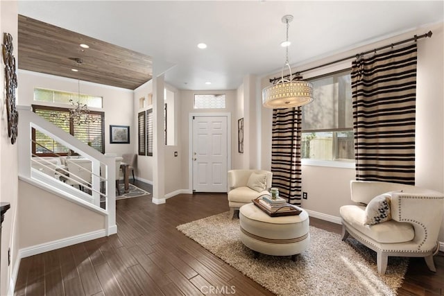 sitting room featuring a chandelier and dark hardwood / wood-style floors