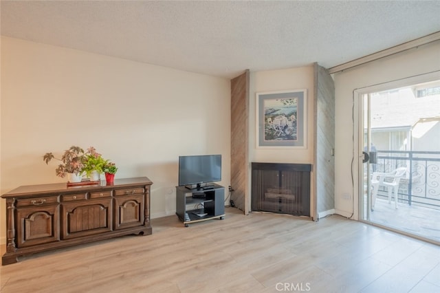 interior space featuring a textured ceiling and light hardwood / wood-style flooring