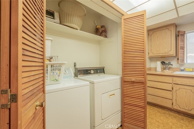 laundry area featuring washing machine and dryer and sink