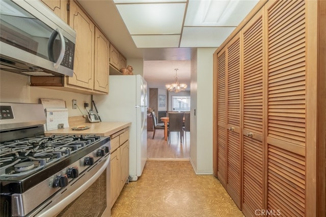 kitchen featuring hanging light fixtures, light hardwood / wood-style flooring, a chandelier, light brown cabinetry, and appliances with stainless steel finishes