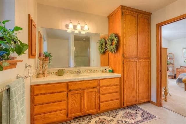 full bath with vanity and a shower with door
