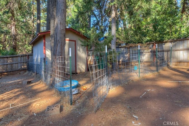 view of shed featuring fence