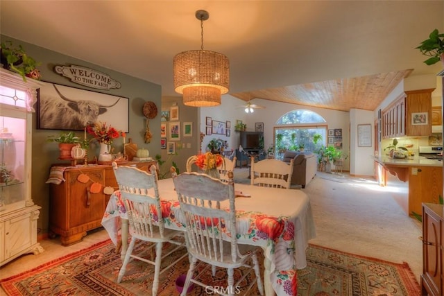 dining space with light carpet and ceiling fan