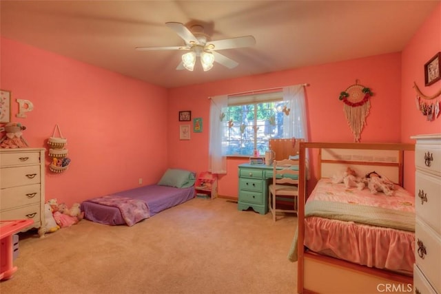 bedroom with a ceiling fan and carpet