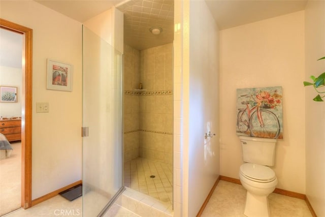 full bath featuring baseboards, a stall shower, toilet, and ensuite bathroom