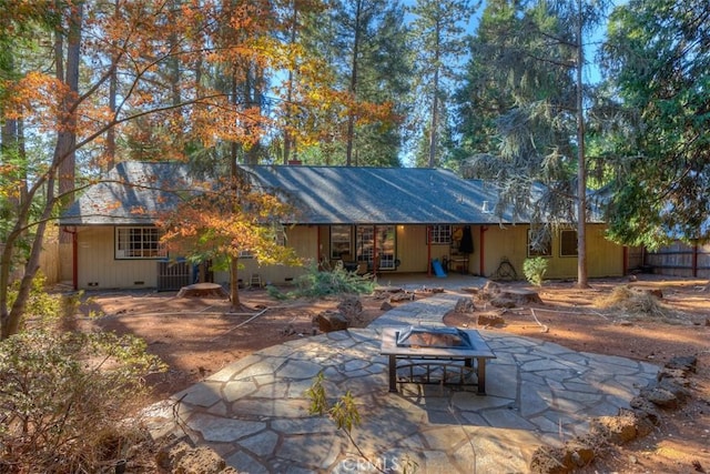 back of property featuring a patio, a fire pit, and fence